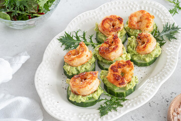 Cucumber Avocado Shrimp Appetizer. Canape with prawn, cucumber and guacamole, party food, finger food