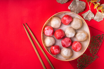 Traditional Chinese lunar New Year dinner table, party invitation, menu background with pork, fried fish, chicken, rice balls, dumplings, fortune cookie, nian gao cake, noodles, chinese decorations