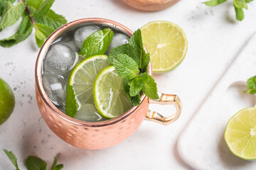 Moscow mule alcoholic cocktail in copper mug with lime, mint and cucumber - Powered by Adobe