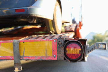 Broken or damaged car on tow truck