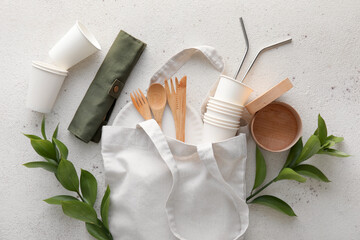 Tote bag with Eco tableware and plant branches on white background