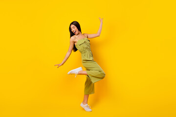 Fototapeta na wymiar Full body portrait of cheerful gorgeous vietnamese lady enjoy dance entertainment isolated on yellow color background