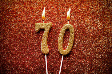 Number 70 seventy candle on glitter background