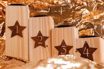 Advent candle holder with numbers 1, 2, 3 und 4. Golden background