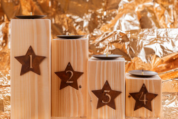 Advent candle holder with numbers 1, 2, 3 und 4. Golden background