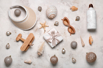 Travel accessories with Christmas decor and seashells on grunge background