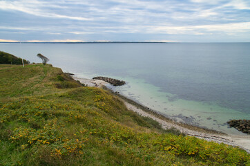 Fototapeta na wymiar Hundested, Denmark on the cliff overlooking the sea. Baltic Sea coast, grassy