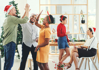 Christmas, party and high five with business people having fun in their office together during the festive season. Team, motivation and celebration with a man and woman colleague group at work