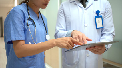 Doctors making a discussion together about the medical treatment analysis on a paper or document.