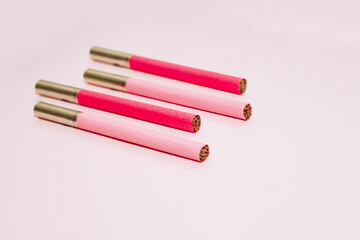 Multicolored cigarettes on a paper background, the concept of a bad habit.