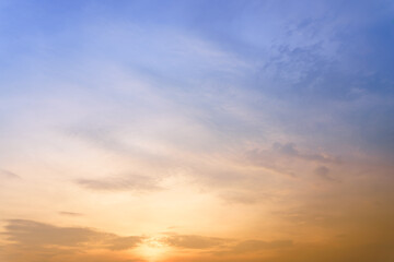 Beautiful cloudy sky after the rain between the sunset in gradient blue and yellow color tone. 
