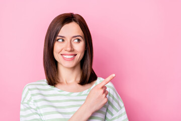 Photo of cheerful gorgeous cute girl with bob hairstyle wear striped t-shirt indicating look empty space isolated on pink color background