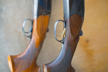 Two double-barreled shotguns stand on a stand. Weapon close-up, rifle for hunting. - obrazy, fototapety, plakaty