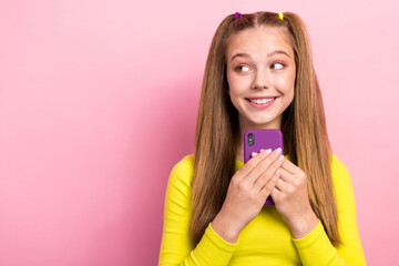 Photo of cheerful girlish lady blogger interested look empty space modern device gadget discounts isolated on pink color background