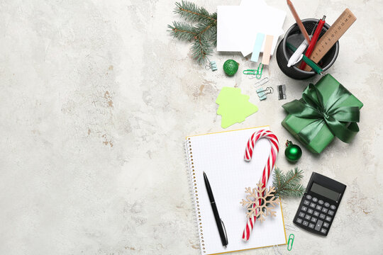 Stationery supplies with Christmas decor and gift on grunge background
