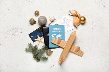 Traveler accessories with Christmas decor on light background