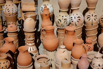 Fototapeta na wymiar Oman Hand Made Pottery in Nizwa Market. Clay Jars at the Rural Traditional Arabic Bazaar, Oman. 