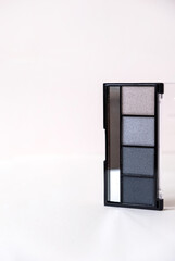 Beautiful eye shadows on white background. Professional makeup product.