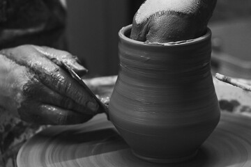The craftsman makes clay jugs in his workshop