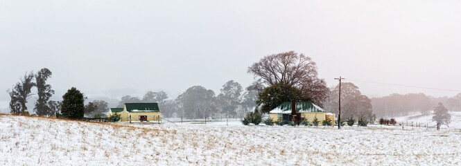 Farm house and outbuildings in the snowy landscape