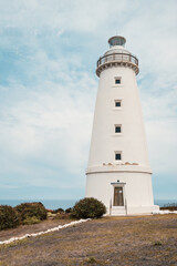 Fototapeta na wymiar Cape Willoughby active lighthouse viewed against blue sky with clouds on a day, Kangaroo Island, South Australia