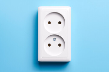 White double socket isolated on blue background. Electric lighting concept