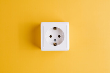 White socket isolated on yellow background. Electric lighting concept