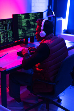 Software developer coding on his computer. Coding and hacking concept.