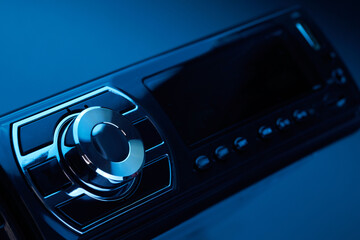 Black car radio tape recorder close-up on black background, audio system, control panel