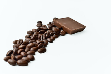 roasted coffee beans with a piece of chocolate on a white background