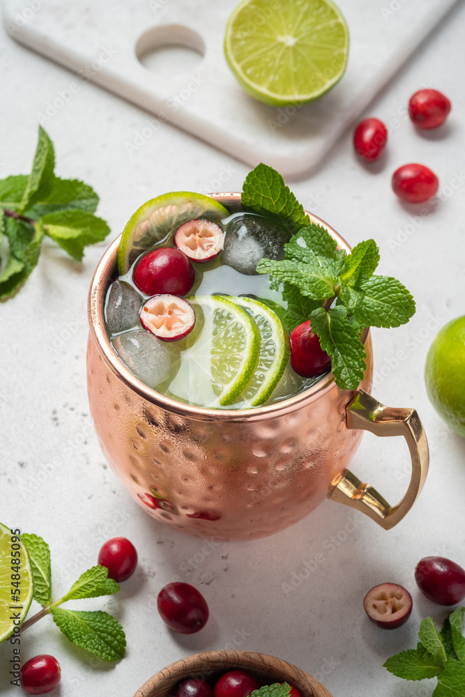 Wall mural christmas moscow mule cocktail with cranberries and lime in copper mugs for christmas