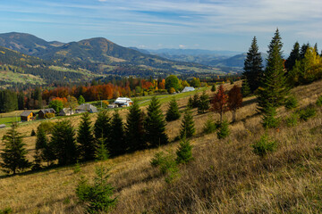 Fototapeta na wymiar Beautiful autumn scenery. Fabulous autumn view of the mountain valley. Gorgeous morning scene of mountain village, Carpathians, Ukraine, Europe. Beautiful autumn scenery
