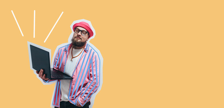 Young crazy bearded charismatic man. Shocked or surprised expression. Laptop concept. Funny promotion poster. Programmer, web developer holding a laptop in his hands and looking at the camera
