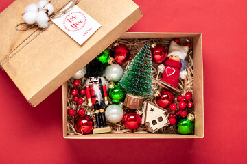 Handmade care package, seasonal gift box with toys, xmas decor on red table Personalized eco...