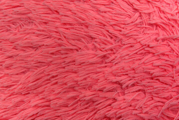 Fototapeta premium Texture bright pink faux fur close-up. Top view. Fur product as background. Trendy neon color