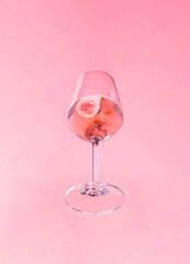 Minimal concept with wine glass on sunny day. Creative party idea, drink in the air. Fig cocktail...