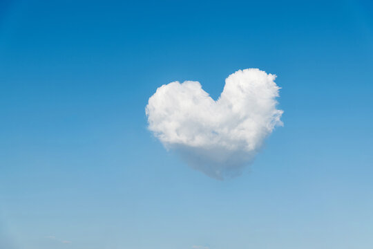 White heart shaped cloud in the blue sky