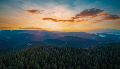 Valley of Balkan mountains with fog, sunny clouds and forests. Village Pamporovo. Panorama, top view