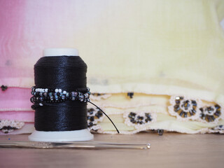 A spool of beaded thread used for needlework.  Selecred focus. Copy space.