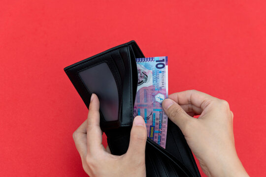 Woman Hand Holding A Wallet With Hong Kong Dollar