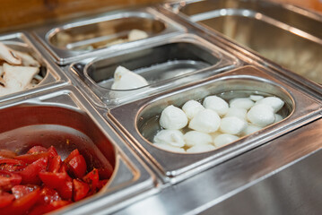 Pizza ingredients in separate bowls