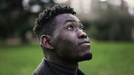 Young black man closing and opening eyes in meditation and contemplation. African person taking a deep breath2