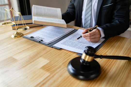 Attorneys or lawyers businessman working or reading lawbook in office workplace for consultant lawyer concept.
