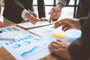 Business people using pen,tablet,notebook are planning a marketing plan to improve the quality of their sales in the future. Business Corporate People Working Concept