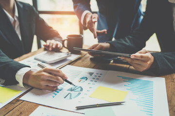 Business meeting team. Photo young account managers crew working with new startup project. Notebook on wood table. Idea presentation, analyze plans.