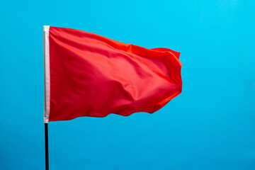 Red flag waving on blue background