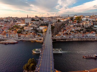 Aerial shot of the Dom Luis I Bridge during a golden sunset hour