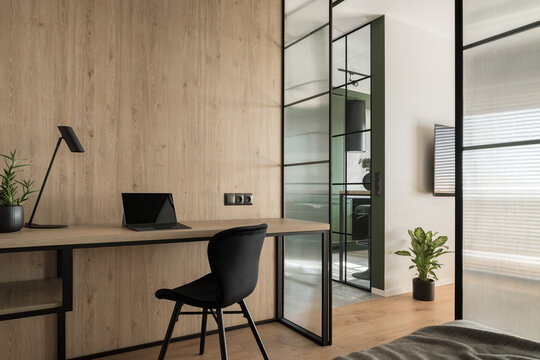 Home office interior with wooden wall
