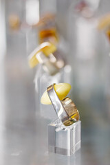 Silver ring with amber on a glass stand on the shelf