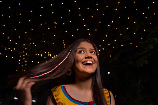 Portrait of an excited woman with braided hair in multicoloured threads